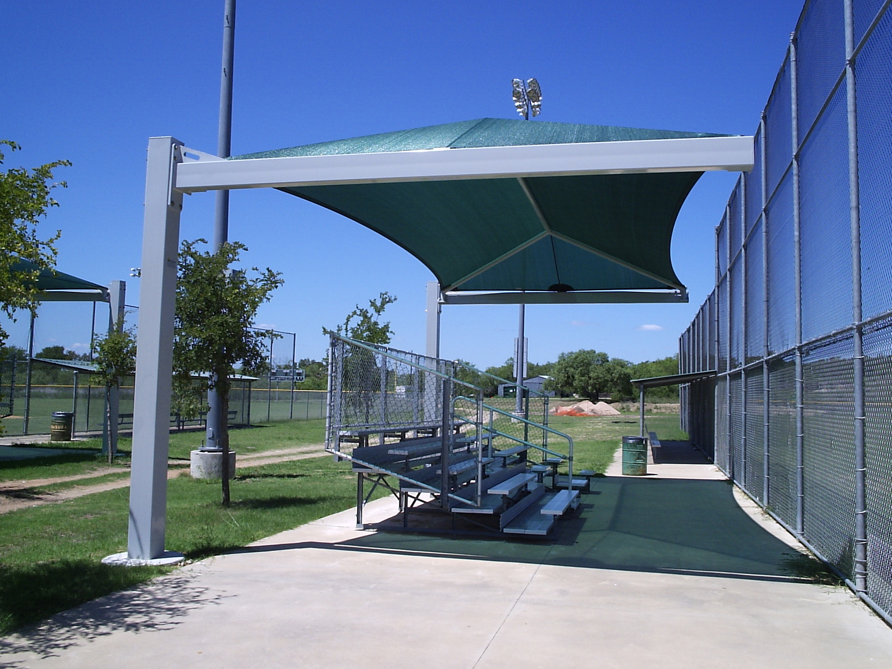green usa shade covering baseball field bleachers