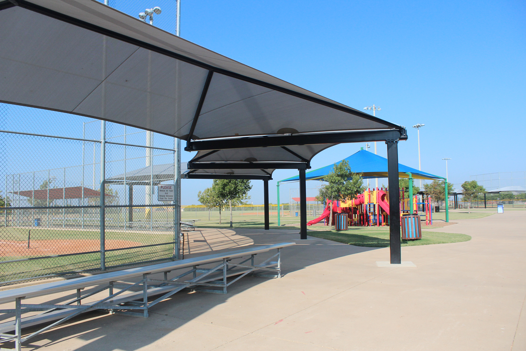 multiple usa shades covering bleachers and playground