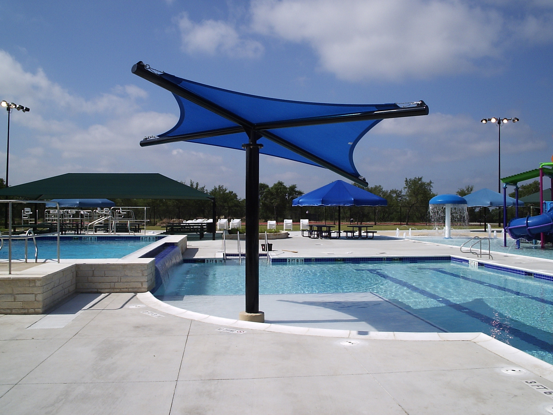 outdoor pool shaded by blue usa shades