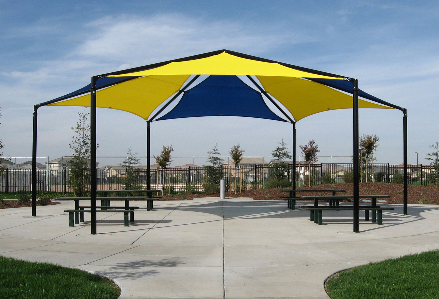 large hexagon shade covering picnic tables