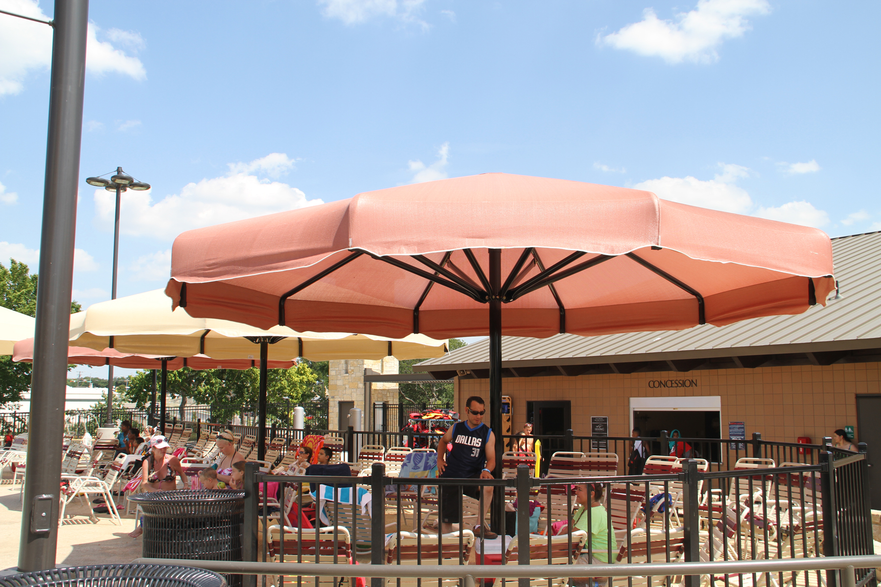 large umbrella shades covering people sitting outdoors