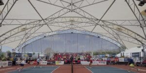 pickleball courts, people playing pickleball, courts protected from sun by shade covering