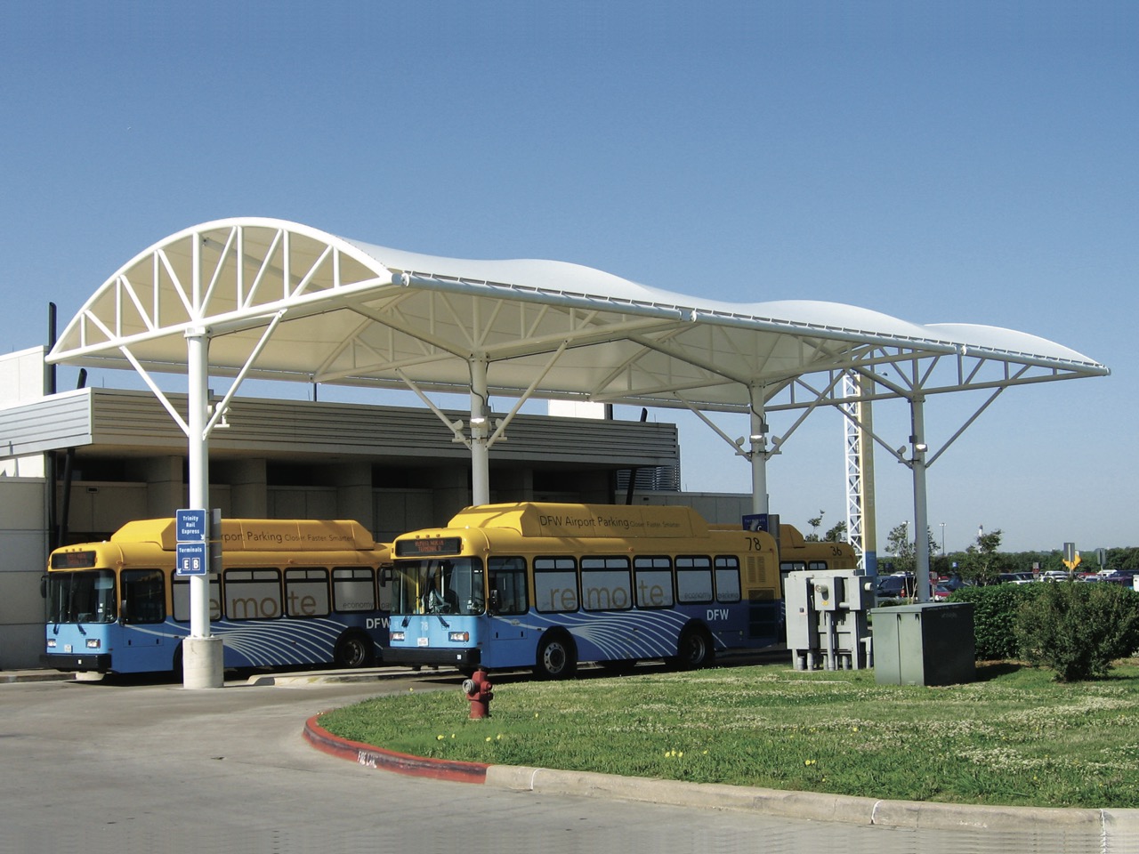 buses at a bus station under a canopy